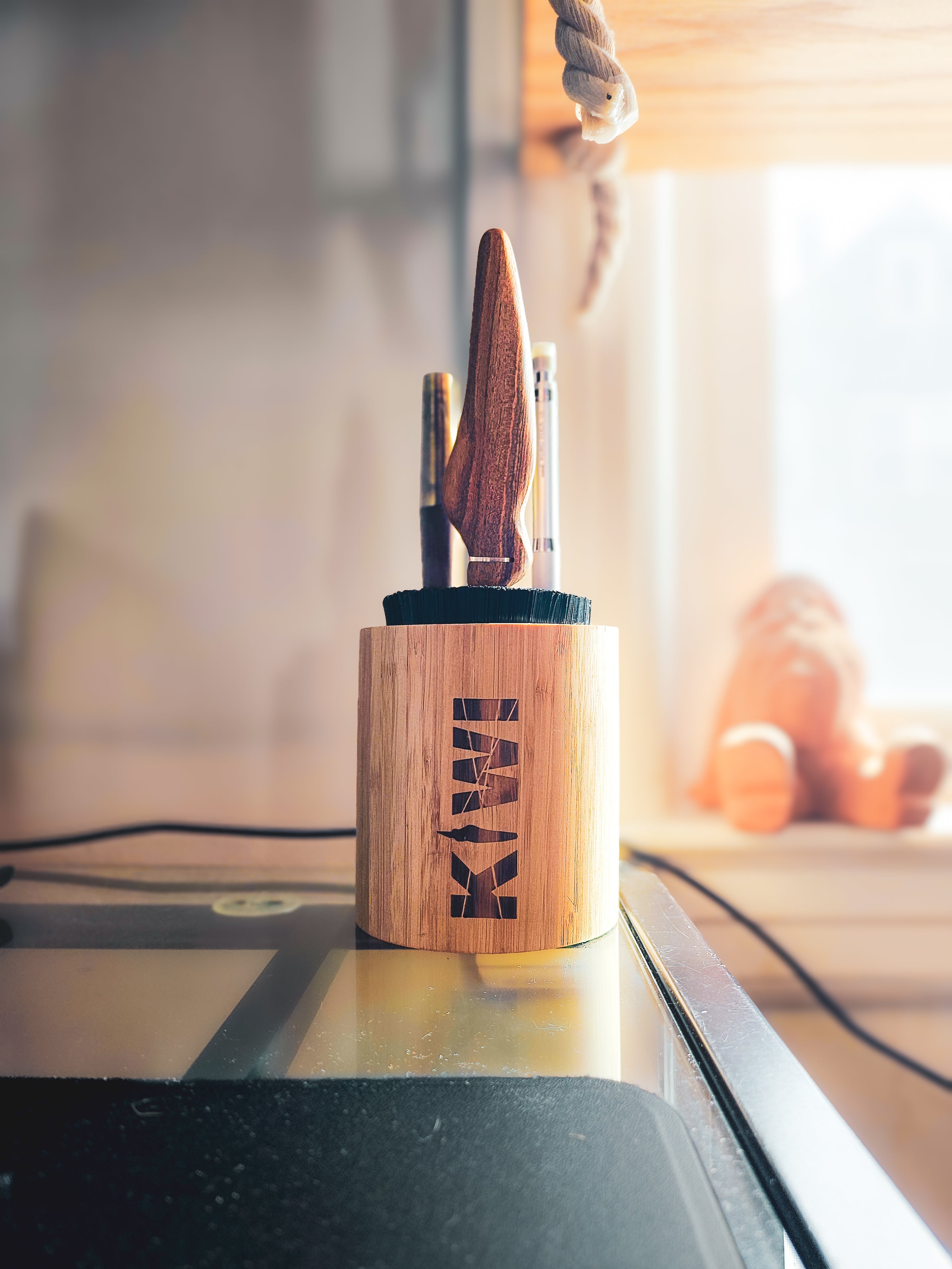 Kiwi Nest: On the desk — Kiwi Nest by the window in warm afternoon light